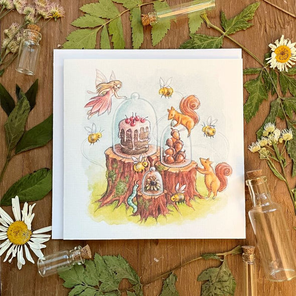 aubree sue art greeting card with watercolor illustration of fairy, squirrels, bees and caterpillar, enjoying desserts of cherry cake, acorns, flowers, blank inside with envelope