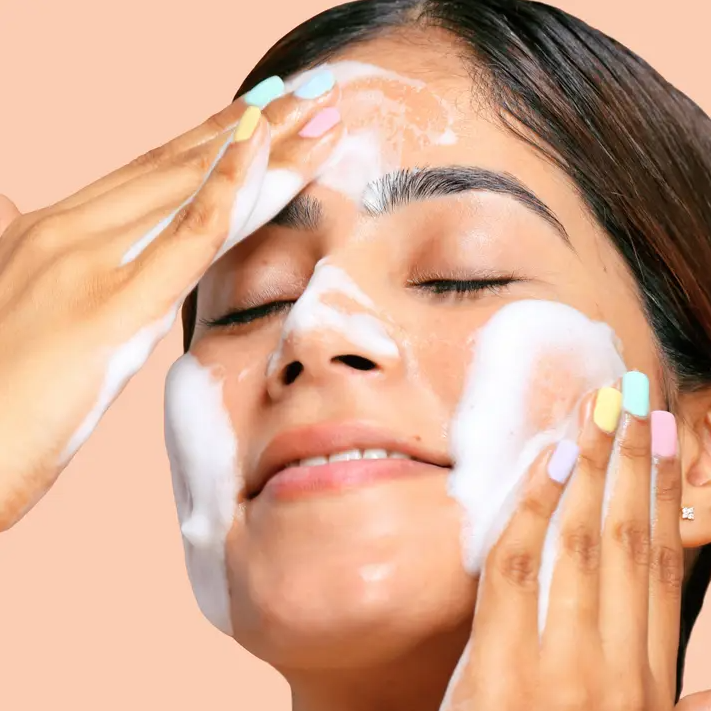 Woman applying My Spa Life Daily Calm  Foaming Facial Cleanser with her hands 