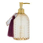 Decorative jasmine and sandalwood sccented hand wash bottle with gold pump and tassel on a white background