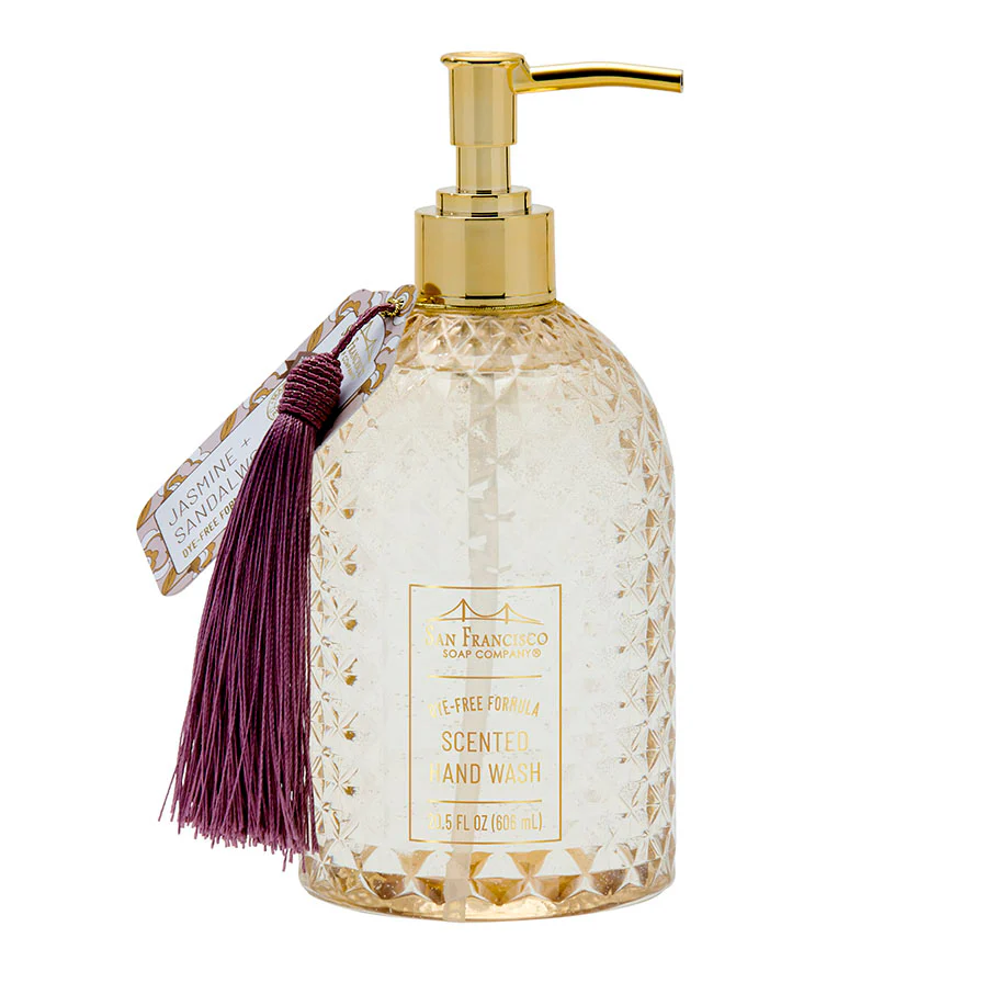 Decorative jasmine and sandalwood sccented hand wash bottle with gold pump and tassel on a white background