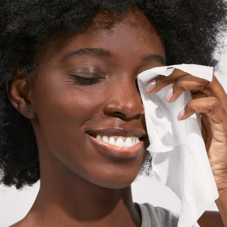 woman using beekman goat milk facial wipes to clean face