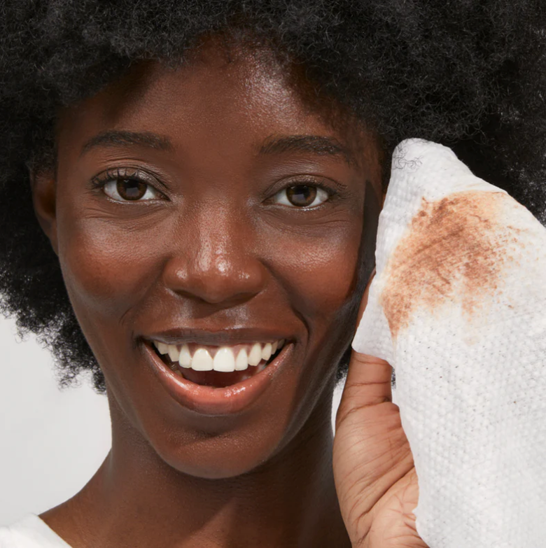 woman using beekman goat milk facial wipes to clean face