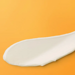 soap bark and chamomile deep cleansing cream smoothed on an orange background creamy texture