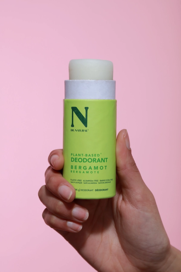 hand holding open light green deodorant stick plastic free packaging zero waste deodorant bergamot scented deodorant