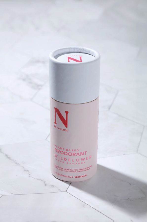 stick of deodorant sitting on tile plastic free packaging light pink color wildflower scented deodorant zero waste deodorant small business