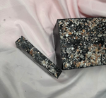 Slice of Bamboo Charcoal Primal Elements Soap, Himalayan Salt Rocks cover the top, jet black soap bar