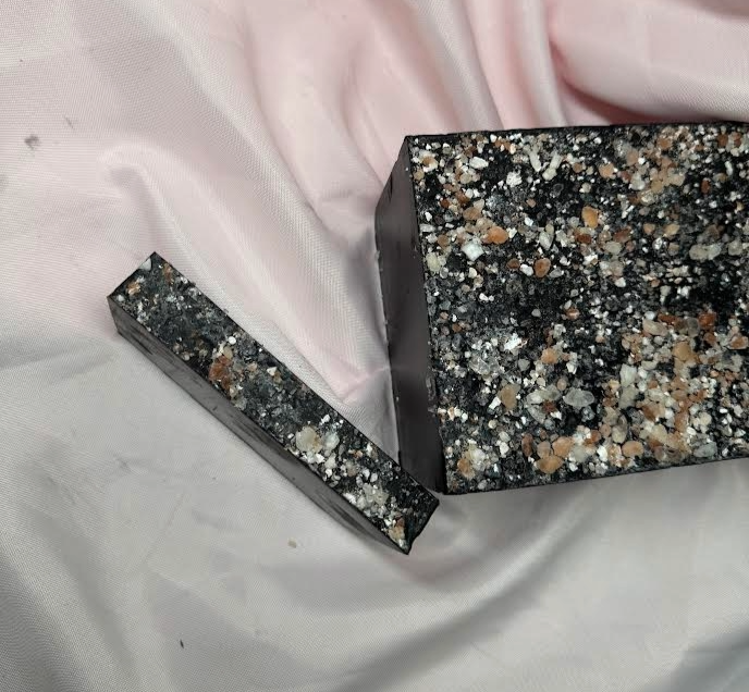 Slice of Bamboo Charcoal Primal Elements Soap, Himalayan Salt Rocks cover the top, jet black soap bar