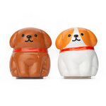 Two dog shaped lip balm containers in brown and orange 