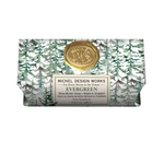 Michel Design Works Evergreen Shea Butter Soap in a 9.7 oz paperboard packaging featuring a green pine tree pattern, a gold wax seal, and a white label.
