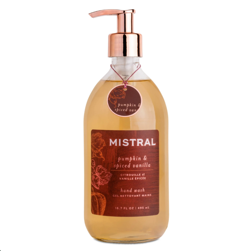 A glass bottle of Mistral hand wash with pumpkin and spiced vanilla scent, featuring a copper pump dispenser and a dark brown label, shown on a white background.