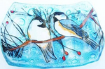 Decorative glass soap dish with two chickadee birds on a branch against a blue background