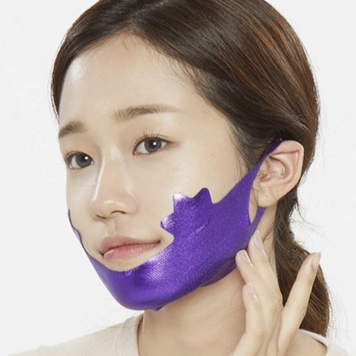 A woman models the Patch Holic purple double chin mask. It wraps around her chin and is held in place with ear loops.