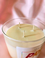 colorful wicks of pride candle on pink cloth