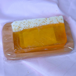 Yellow IPA beer alcohol soap bar with white top foam on a wooden soap dish, on a white background