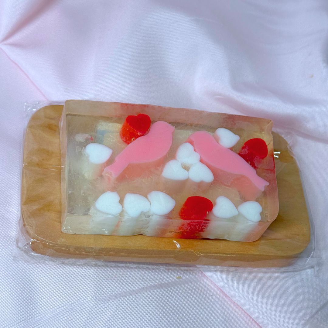 Novelty Valentine's Day Just Because Hearts and Love Birds soap bar with pink birds and red hearts and white hearts on a white background on brown wooden soap dish