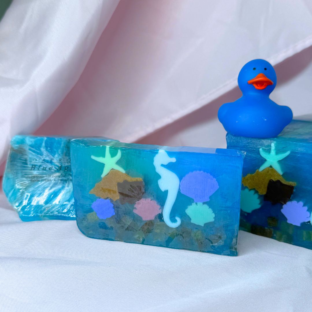 Blue vegetable glycerin decorative soap with underwater scene seahorse shells starfish coral design on a white background with Soap Rocks Blue Agate and blue rubber duck blue underwater scene