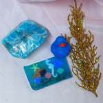 Blue vegetable glycerin decorative soap with underwater scene seahorse shells starfish coral design on a white background with gold coral and Soap Rocks Blue Agate and blue rubber duck