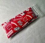 A red and white Wisconsin Badgers themed lavender scented eye pillow in plastic bag