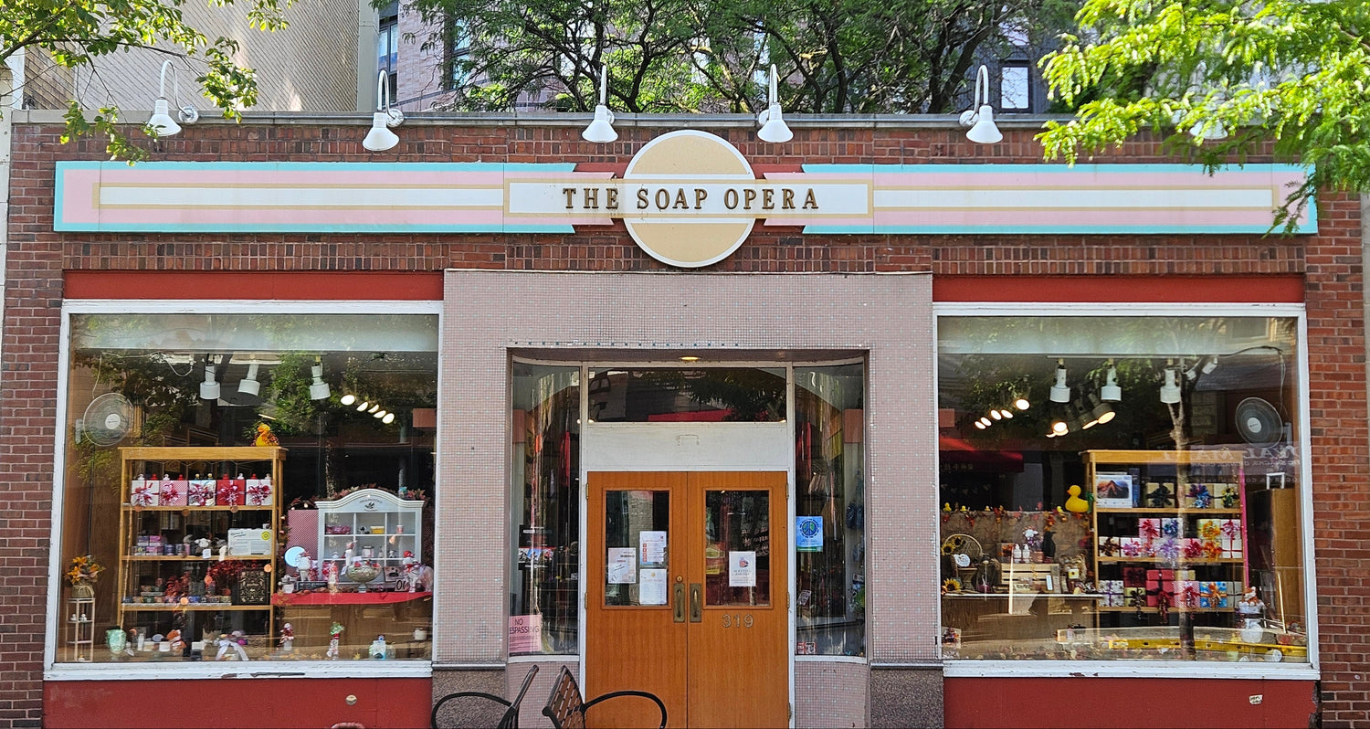 Storefront of 'The Soap Opera' with brick facade and large windows.