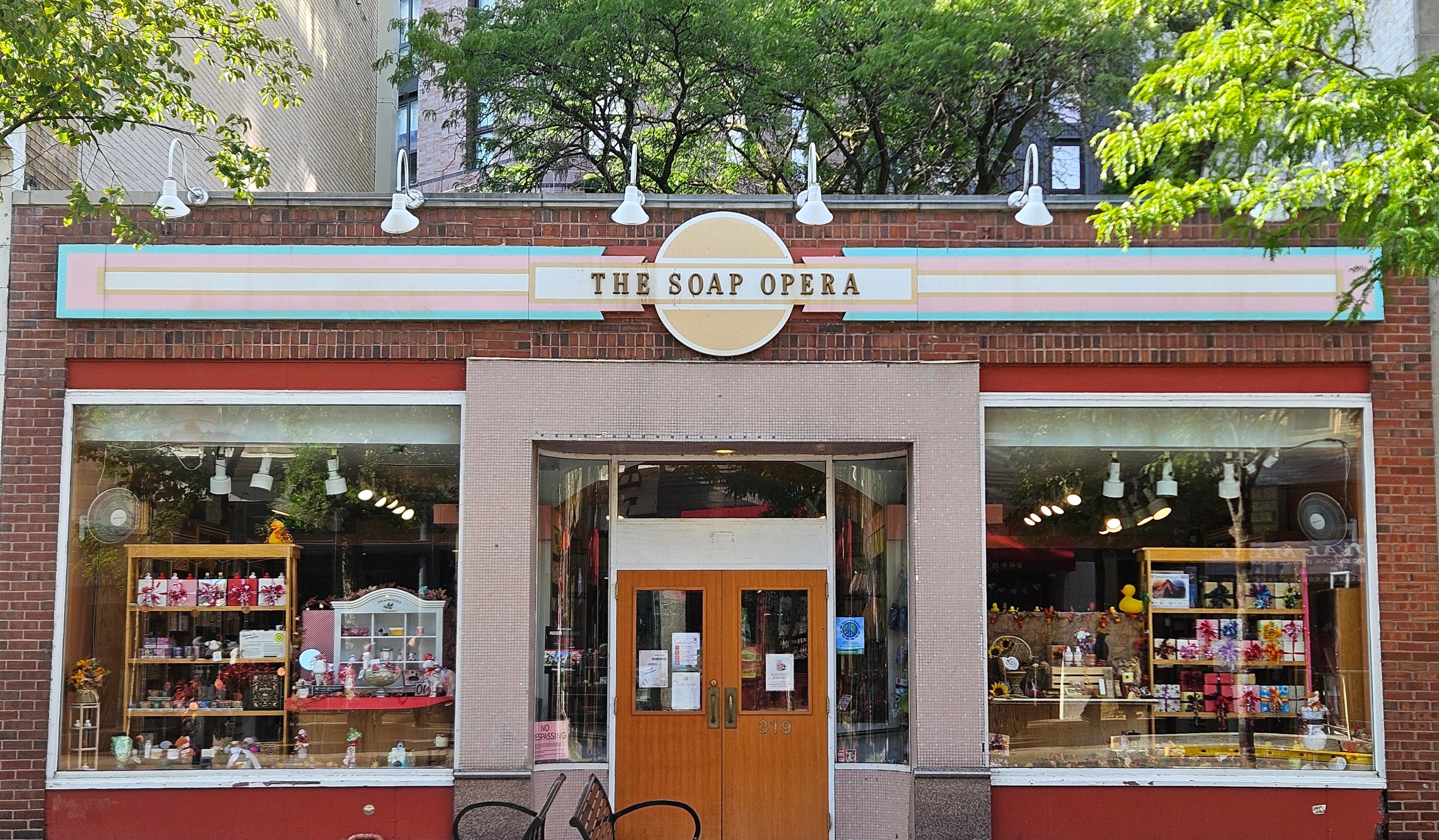Storefront of 'The Soap Opera' with brick facade and large windows.