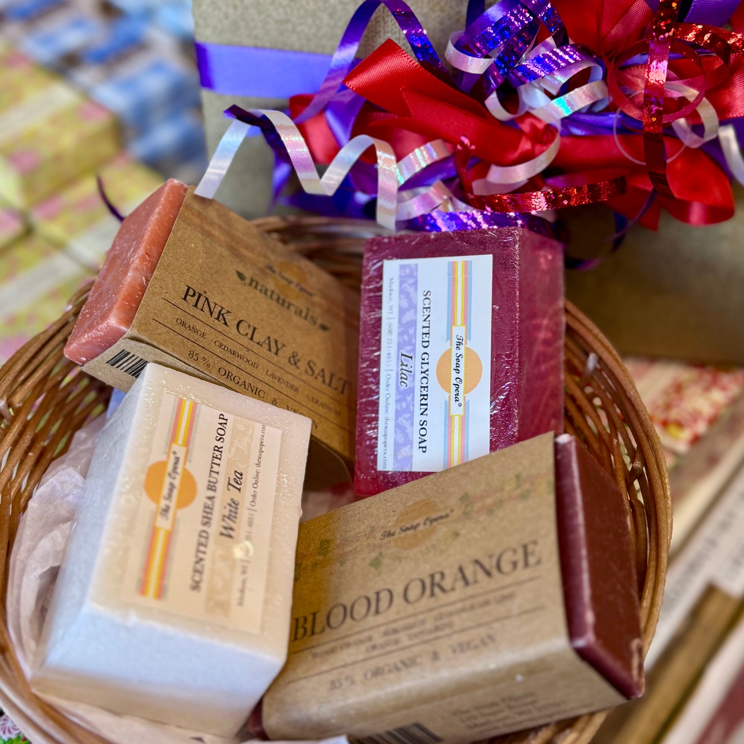 Four soaps themed for love and valentines day that come in a gift box wrapped with a bow