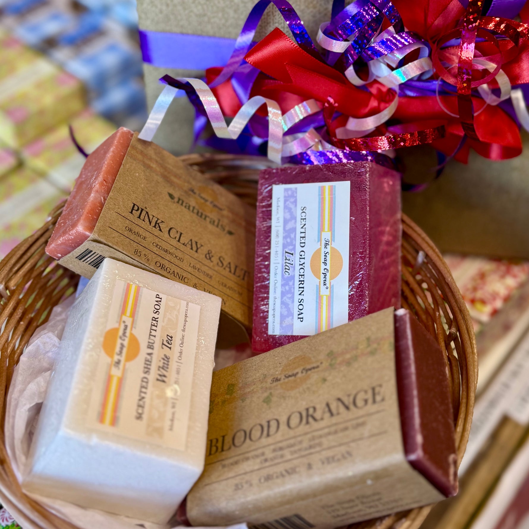 Four soaps themed for love and valentines day that come in a gift box wrapped with a bow