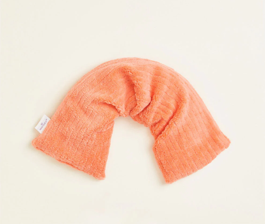 A coral orange tube-shaped Warmies Hot-Pak, folded into an upside-down U shape.