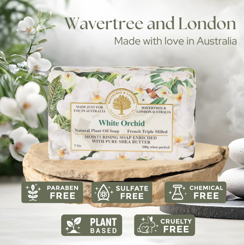 A bar of Wavertree and London White Orchid soap displayed on a wooden slice pedestal, with white orchid flowers and green leaves in the background. Text at the top reads 'Wavertree and London Made with love in Australia', and feature badges at the bottom highlight 'Paraben Free', 'Sulfate Free', 'Chemical Free', 'Plant Based', and 'Cruelty Free'.