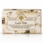 A rectangular bar of Wavertree & London Goats Milk Natural Plant Oil Soap, wrapped in a cream-colored paper sleeve decorated with illustrations of white goats and rustic barrels, set against a plain white background with a soft reflection.