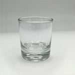 A clear glass votive candle holder with a heavy bottom.
