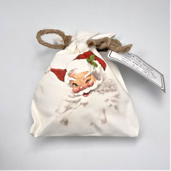 mary lake thompson soap in canvas bag tied at the top holiday christmas gift with santa illustration on front winking