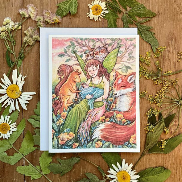 aubree sue art greeting card with watercolor illustration of fairy mom and baby surrounded by woodland animals and flowers. fox, squirrels, peacock, owls. good for baby shower or mothers day.