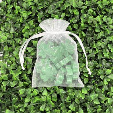 white sachet bag full of small green shamrock clover shaped spearmint chocolate scented bar soaps for st patricks day